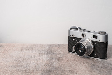 Old film camera on a gray background