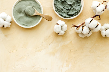 Blue cosmetic clay on beige background top-down copy space