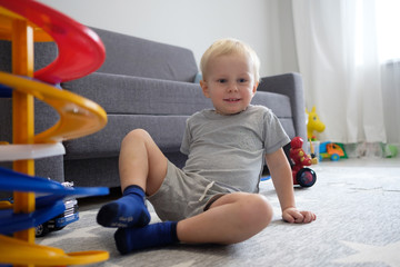 Fototapeta premium Dad plays with his son in the nursery
