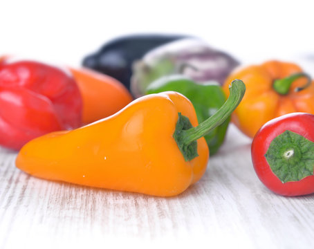 Yellow Hot Pepper Among Colorful Others On White Table