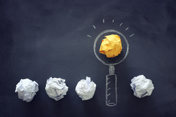 Education concept image. Creative idea and innovation. Magnifying glass as finding the right target metaphor, over blackboard