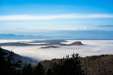 Panoramic view over the valley with fog and castle on the hill. Spisky Hrad, Slovakia