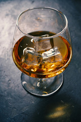 Whiskey, Brandy, cognac, in a glass with ice