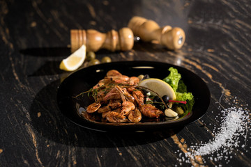 large shrimps, king prawns, black dish shrimp serving, boiled and fried shrimps, smoked shrimps, close-up