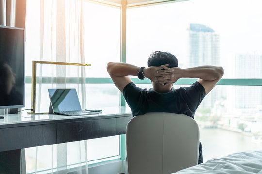 Life-work balance and city living life style concept of business man relaxing, take it easy in office room resting with thoughtful mind thinking of lifestyle quality looking forward to cityscape