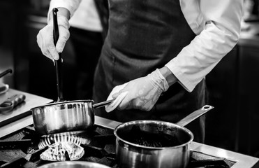 Chef cooking in a kitchen, chef at work, Black and White.