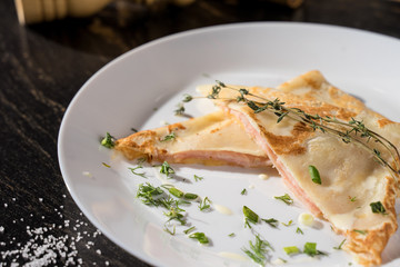 pancakes with ham and cheese sprinkled with herbs restaurant serving