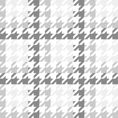 Vector image of a large houndstooth pattern with a gradient gray color scheme.