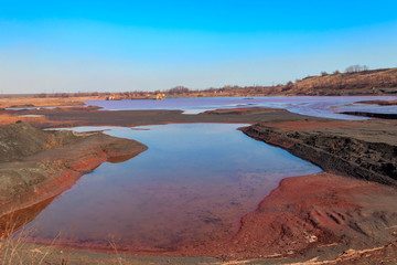 Technical settler of industrial water of mining industry in Kryvyi Rih, Ukraine. Red water polluted with iron ore waste