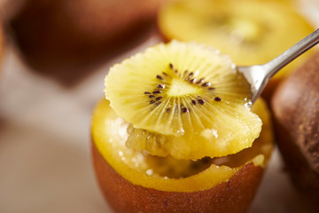Eating gold kiwifruit with spoon