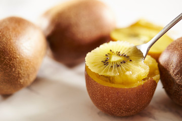 Eating gold kiwifruit with spoon