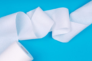 Toilet paper roll on the bright blue background. Coronavirus pandemic panic shopping concept. Bright monochrome drop