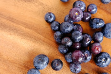 fresh blueberries on wooden table.  Texture blueberry berries. Copy space for your text. top view