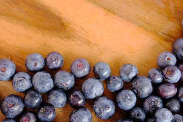 fresh blueberries on wooden table.  Texture blueberry berries. Copy space for your text. top view
