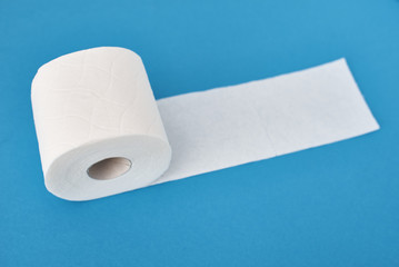 Toilet paper rolls on a blue background. Hygiene concept