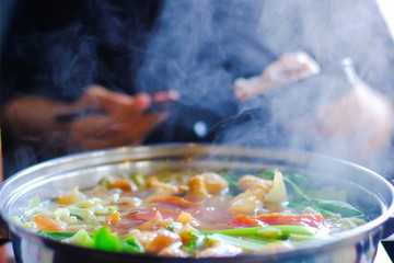 Close up view of hot pot with meat beef sliced and vegetables. Shabu Shabu is style beef in hot pot dish of thinly sliced meat and vegetables boiled in water. delicious food most popular in Thailand.