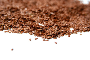 heap of brown flax seeds isolated on white background