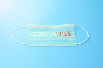 medical concept. corona virus covid-19. face mask on blue desk. free copy space for your text