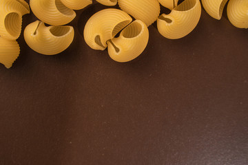 pepe rigate on a brown background, copy space from below