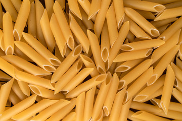 scattering Italian pasta penne, feathers