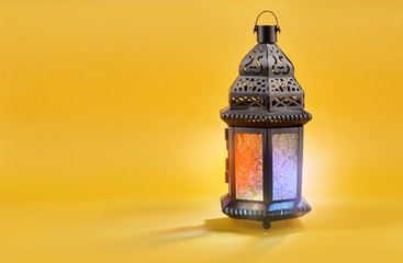 Ornamental Arabic lantern on yellow background.