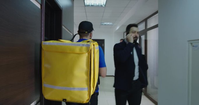 Delivery boy arriving with food