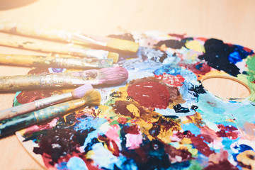 Paint brushes on a palette painted, creativity and art