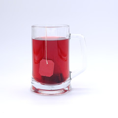 Red Tea glass cup with tea bag. Tea cup isolated on white background.