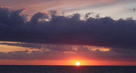 Naklejka na ściany i meble Photo background beautiful sunset on the sea coast