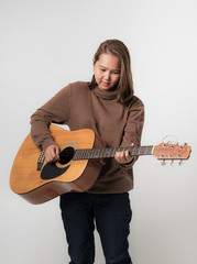 young girl with guitar music concept on white background.