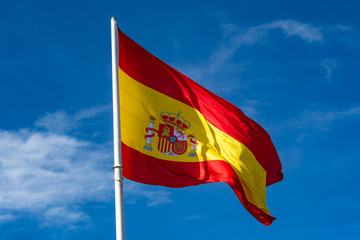 Flag of Spain over blue sky background
