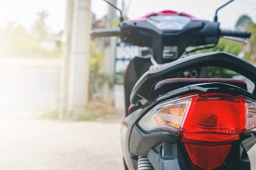 Close-up tail light motorcycle. View of motorcycle parking at home in morning with blurred background.