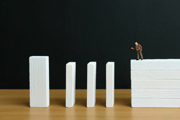 Business strategy conceptual photo - Miniature of businessman stands at the edge of wooden bridge...