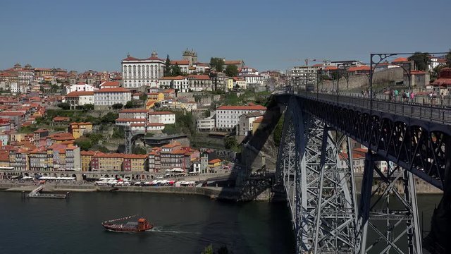 Luis I Bridge over Duro River with the passing Metro train & Porto historical district at background. Portugal.