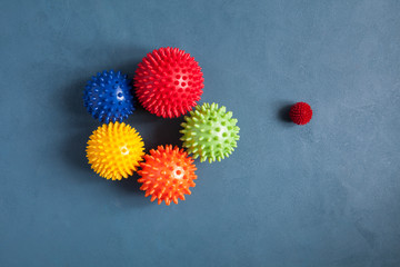 Massage balls on a contrasting background. The abstract appearance of the coronavirus COVID-19.The basis for a collage on the theme of leisure with children or animals during illness or quarantine