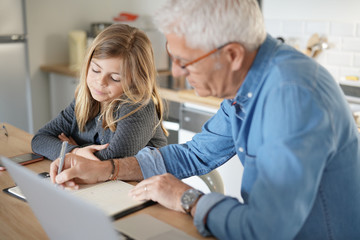 Fototapeta premium Father and child at home doing online school teaching class