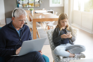 Father and school-girl working form home, telework and e-learning