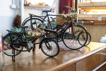 Fototapeta na wymiar Toys metal classic bicycles on wooden table, selective focus