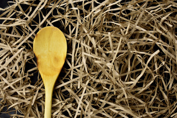 wooden spoon on a light straw background