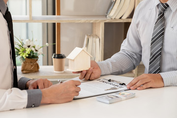 Real estate agent broker with home insurance forms In order for the customer to sign the contract according to the agreement buying home insurance officially Home insurance concept