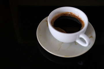 cup of coffee on black background