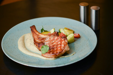 Grilled steak with vegetable salad and sauce. Concept for a tasty and healthy meal. Close up.