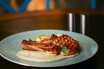 Grilled steak with vegetable salad and sauce. Concept for a tasty and healthy meal. Close up.