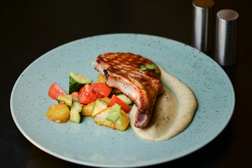 Grilled steak with vegetable salad and sauce. Concept for a tasty and healthy meal. Close up.