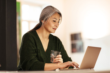 Amazing positive optimistic woman using laptop computer