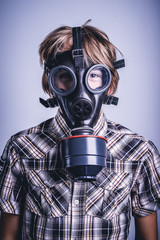 Little boy wearing a protective mask for nuclear bacteriological chemical risk