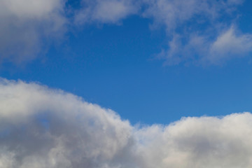 Bright white with grey clouds on blue sky. Beautiful background.