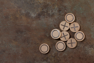 TIC-TAC-toe game wooden on a Turquoise brown background hand painted . Top view, macro.