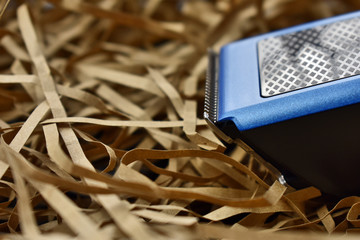 hair clipper on a light straw background