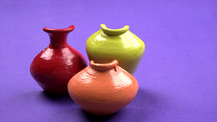 Beautiful empty decorative ceramic pots in warm happy colors on colorful background.